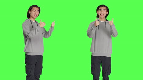 Asian-guy-gives-thumbs-up-in-studio